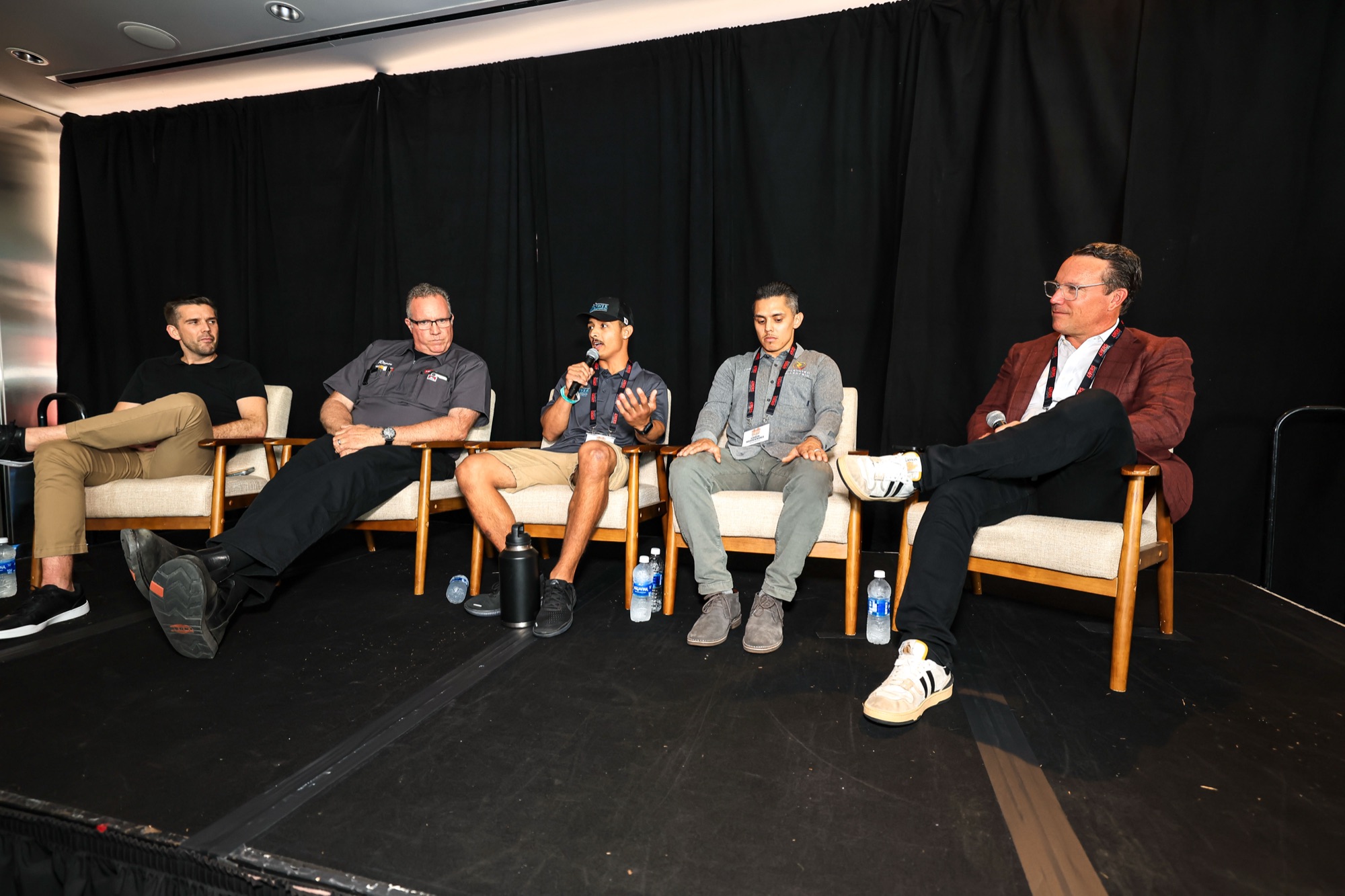 Tradespeople speak on a panel in front of students